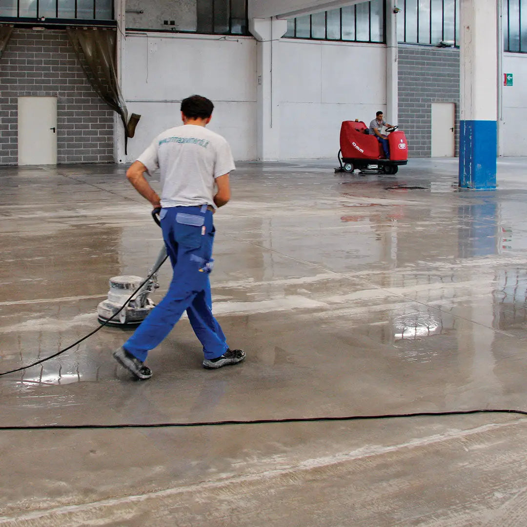 Applying Mapecrete LI Hardener to concrete slab to increase surface strength and resistance.