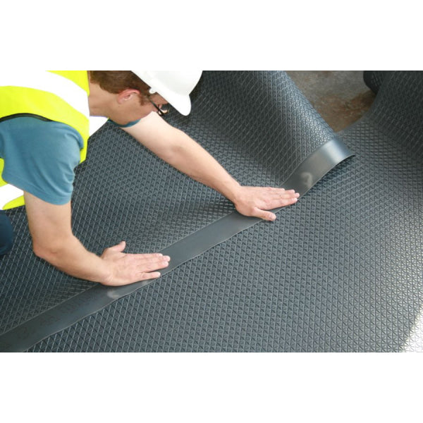 Worker installing black rubber anti-slip floor matting for Newton 601 Slimline Flooring