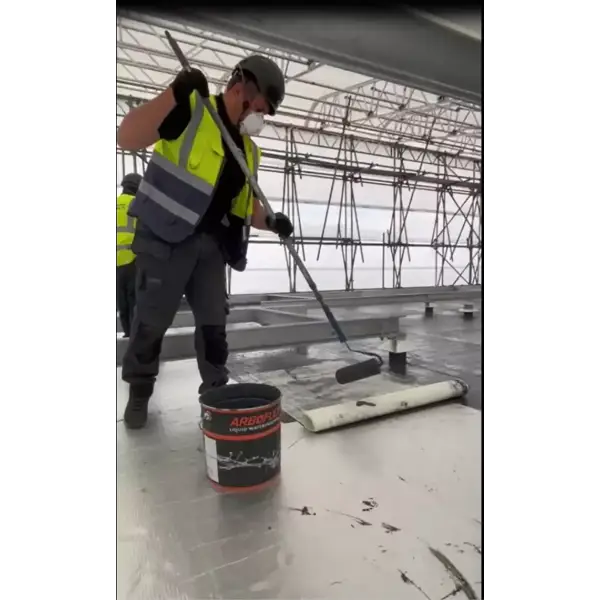 Construction worker applying sealant using Arboflex Roof Kit 2 for 200m2 coverage