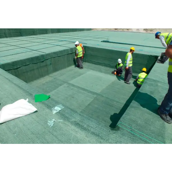 Construction workers applying Wykamol bentonite waterproofing on a concrete surface