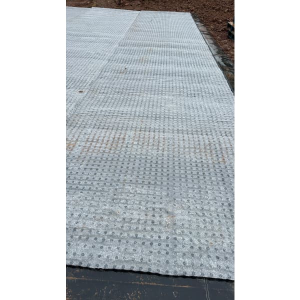 Gray plastic ground reinforcement grid in CleverShield CM20 Geotextile Membrane 2m x 10m