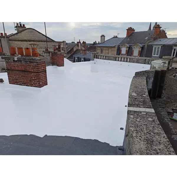 White-coated flat rooftop with brick chimneys on CoolTop product installation