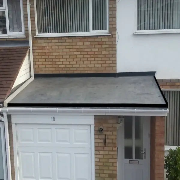 Flat roof over garage and doorway featuring EPDM Porch Roof Kits for durable protection