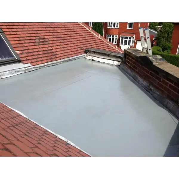 Flat roof section with gray waterproof membrane amid tiled roofs using Flexi-Tec 2020 GRP Kit