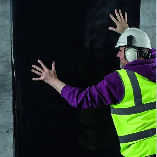 Construction worker in hard hat and safety gear showcasing GP TITAN Tank features