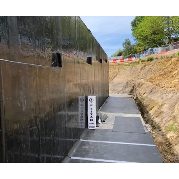 Concrete retaining wall with openings and sign on GP TITAN Tank waterproofing membrane