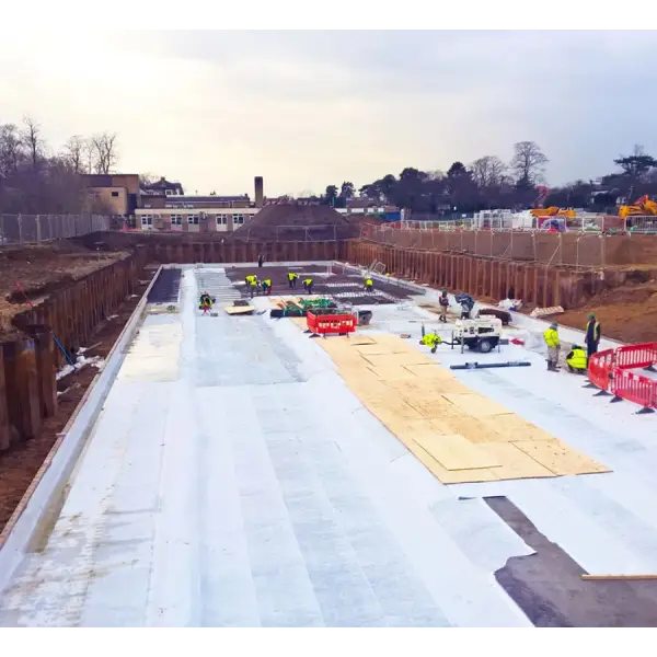 Construction site showcasing Newton Hydrobond 403 Plus with concrete foundation and wooden boards