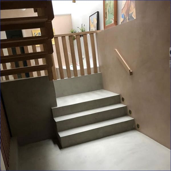 Modern staircase featuring a wooden railing and Microcement Individual Components