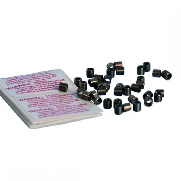 Black plastic tire valve stem caps beside a pink instruction sheet for Lectros Damp Proofing