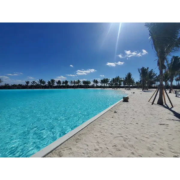 Turquoise lagoon and sandy beach at LEISURELINE Lagoons & Waterparks attraction