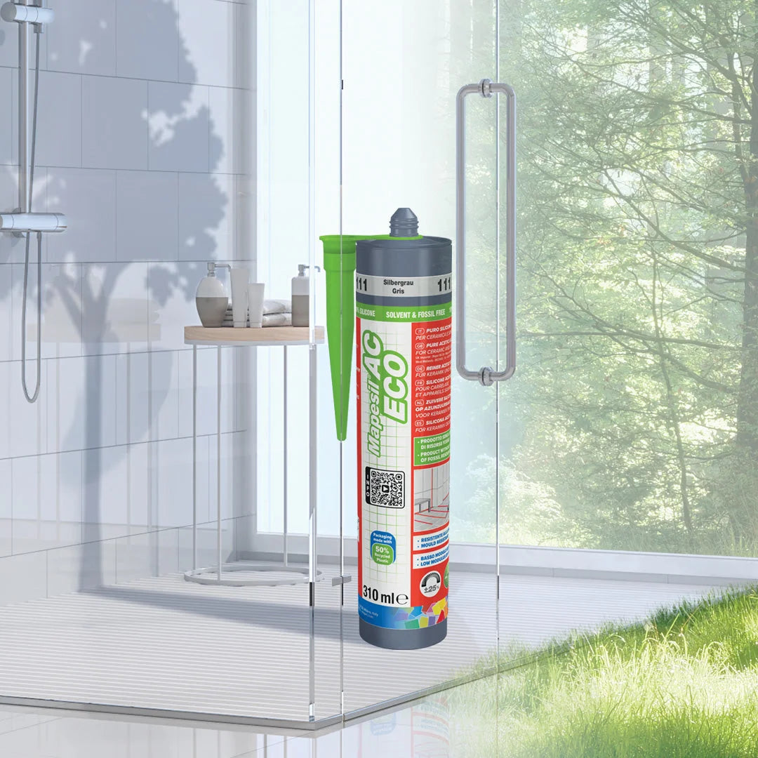 MAPESIL AC ECO silicone sealant tube in a modern glass shower, highlighting eco-friendly and mould-resistant properties for bathroom applications