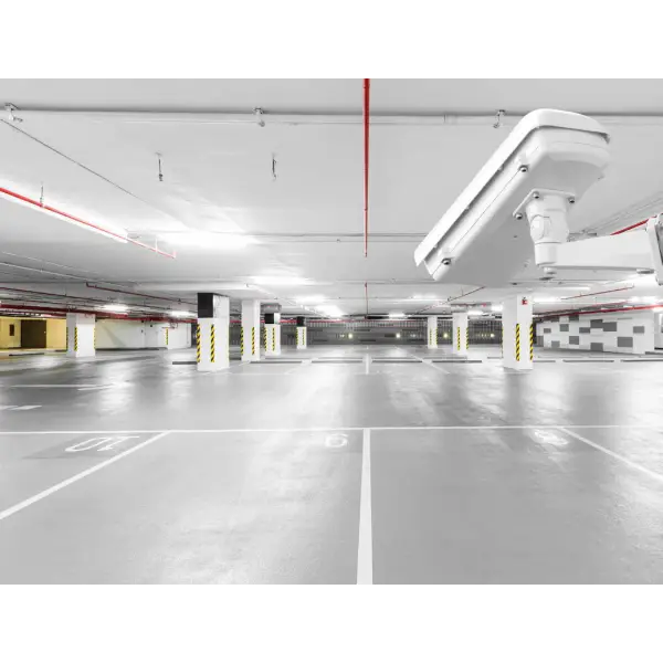 Empty underground parking garage featuring QuickDeck Car Park Decking System and fluorescent lighting