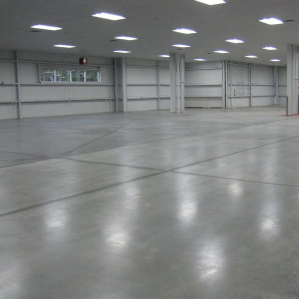 Empty warehouse interior showcasing Sikafloor CureHard-24 flooring solution