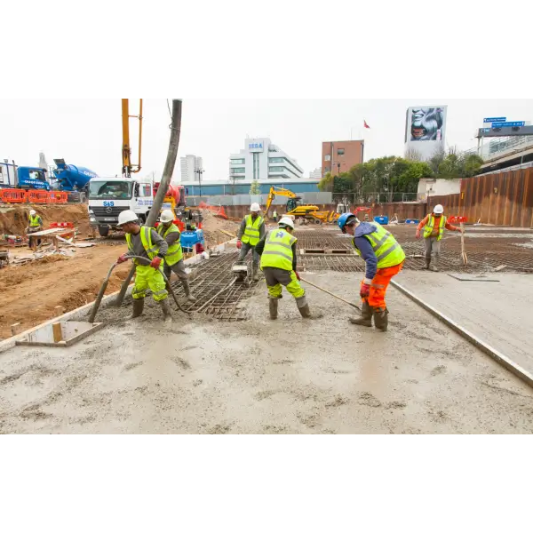 Construction workers pouring concrete while using TT Admix Concrete Waterproofing 4.1Kg