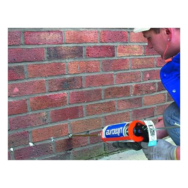 Caulking gun applying sealant to brick wall holes with Ultracure Damp Proofing Cream 600ml