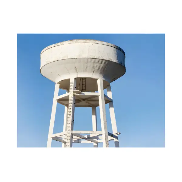 White elevated water tower with cylindrical tank and supporting legs for UltraFlex PW DWI Approved